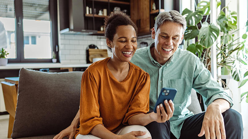 smiling couple on couch